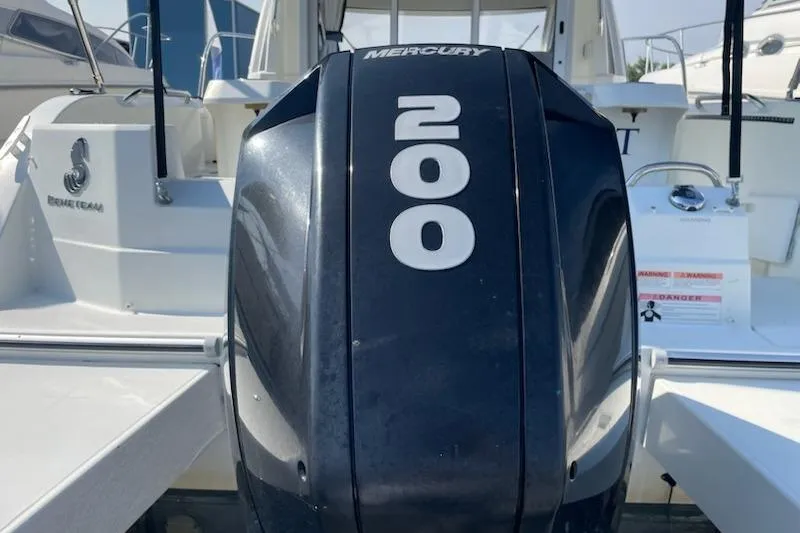 Slide: The Image of 2019 Beneteau Antares 23 with Mercury 200 outboard engine, docked at marina. - 9