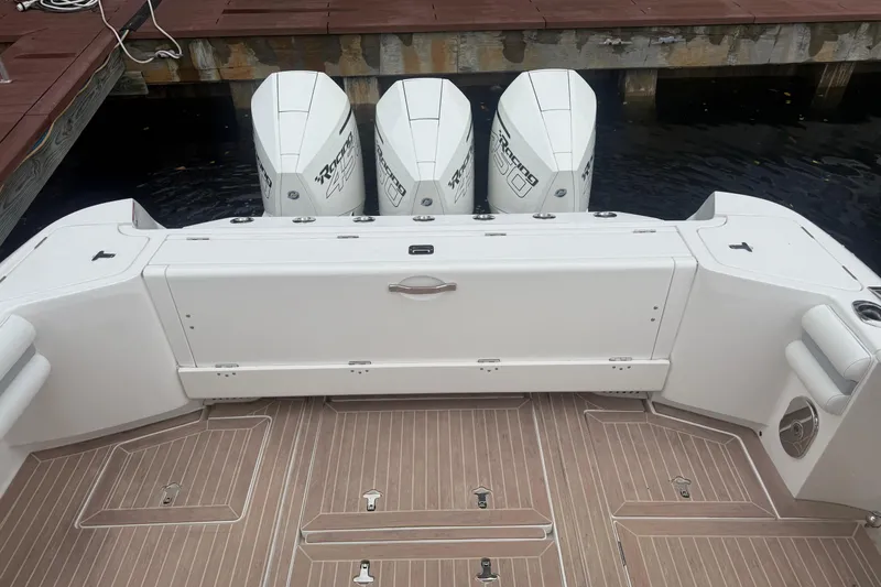 Slide: The Image of 2021 Intrepid 409 Valor boat docked with triple outboard engines. - 11