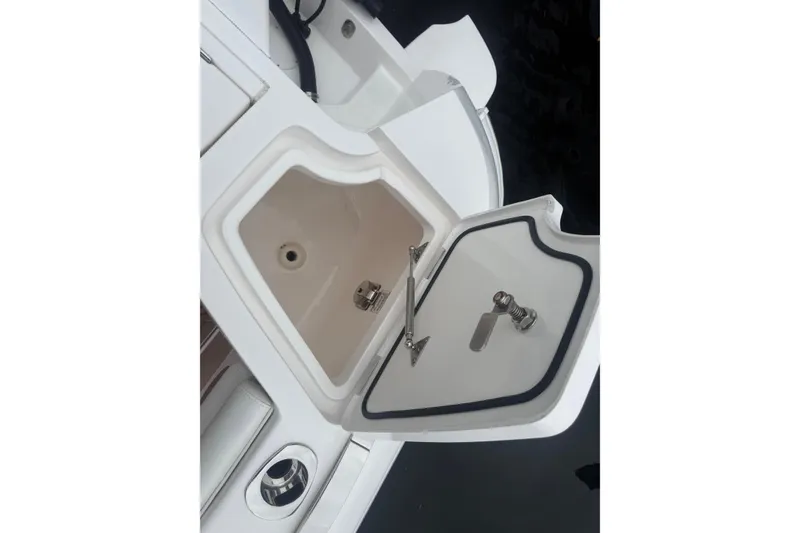 Slide: The Image of 2021 Intrepid 409 Valor boat engines with protective covers, docked in water. - 12