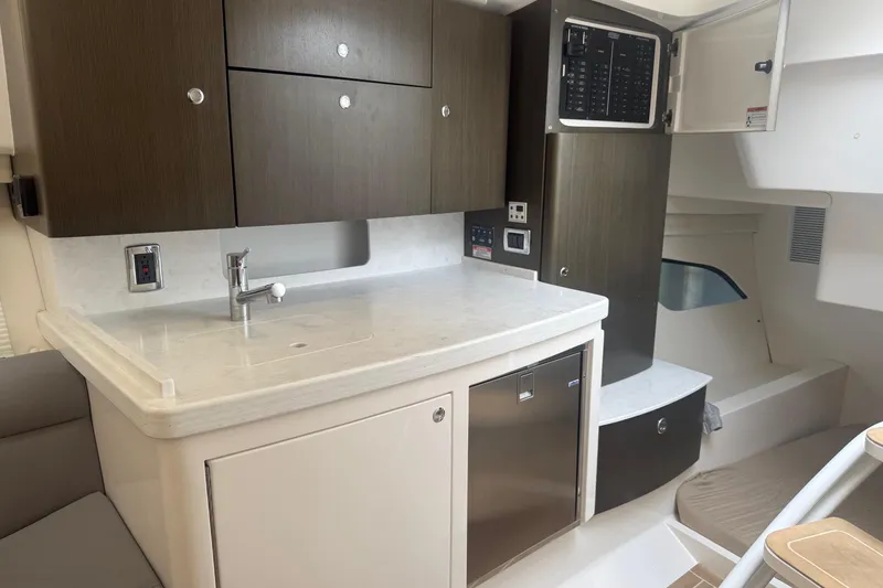 Slide: The Image of 2021 Intrepid 409 Valor boat storage compartment with open lid on teak deck. - 25