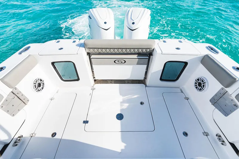 Slide: The Image of Manufacturer Provided Image: 2025 Sportsman Open 302 Center Console boat deck with twin engines on turquoise water. - 13