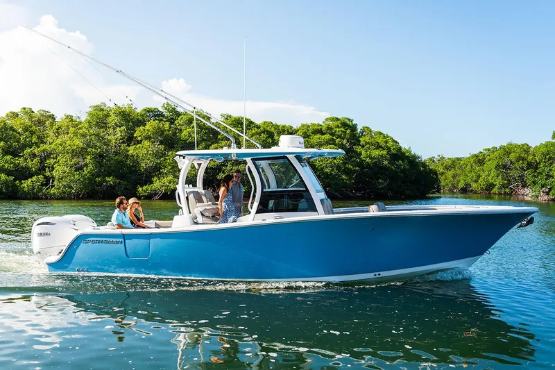 Slide: The Image of Manufacturer Provided Image: 2025 Sportsman Open 302 Center Console boat cruising on a sunny day. - 2