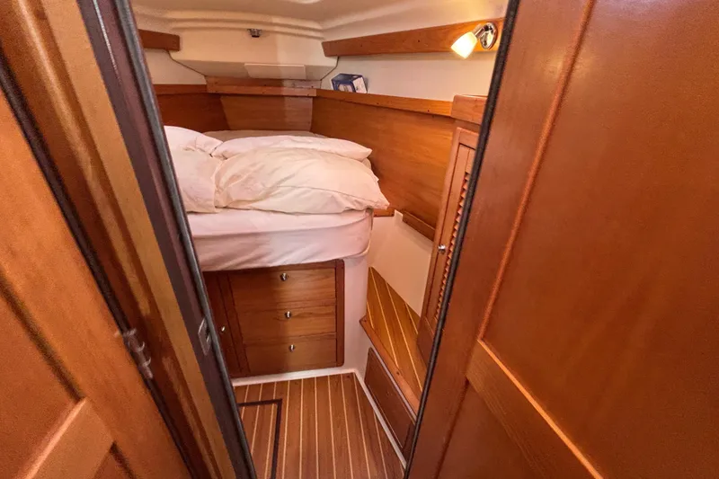 Slide: The Image of Cozy cabin interior of 2004 Catalina 350 sailboat with wooden furnishings and bed. - 10