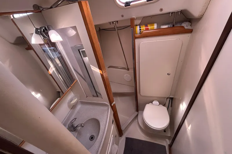 Slide: The Image of 2004 Catalina 350 yacht bathroom with sink, mirror, and toilet. - 15