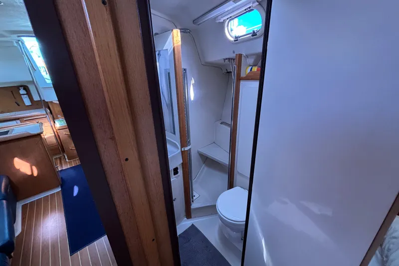 Slide: The Image of Interior of 2004 Catalina 350 sailboat showing bathroom and cabin area. - 17