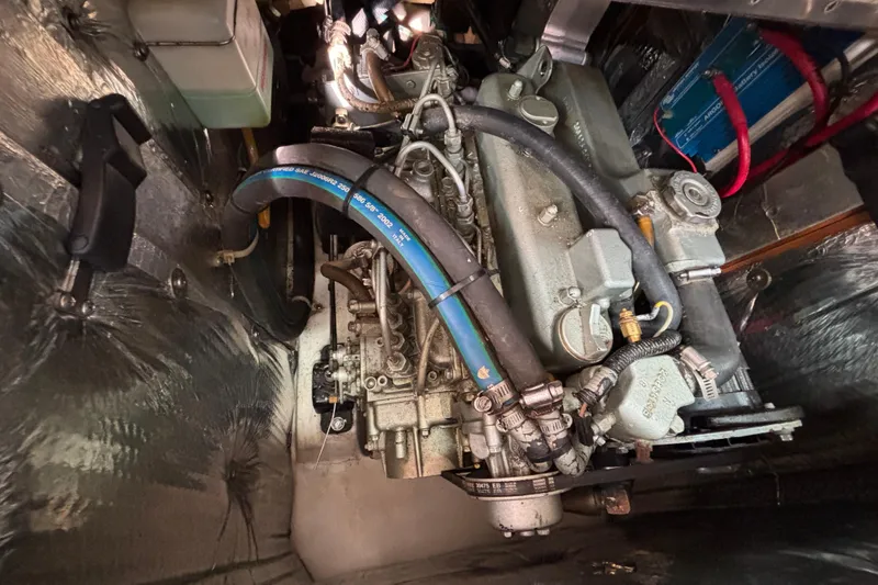 Slide: The Image of Engine compartment of a 2004 Catalina 350 sailboat, showcasing mechanical components and wiring. - 19