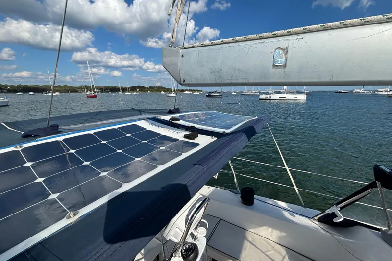 Slide: The Image of Catalina 350 sailboat with solar panels, anchored in a scenic bay, 2004 model. - 23
