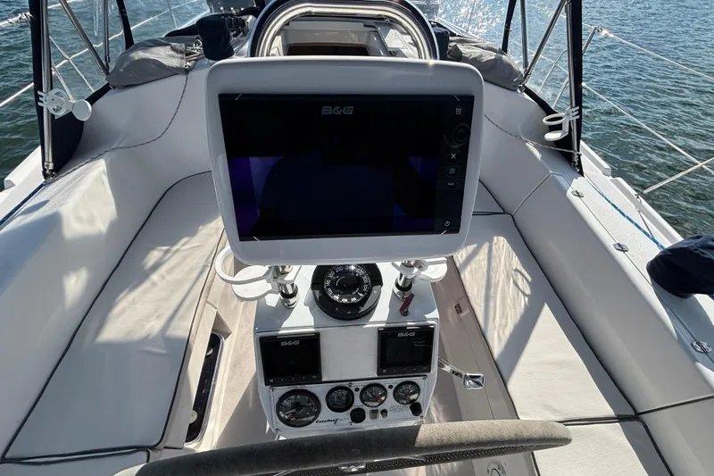 Slide: The Image of Cockpit of 2004 Catalina 350 sailboat with navigation equipment and steering wheel. - 27