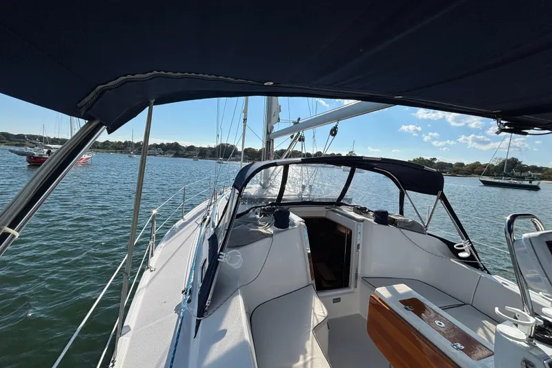 Slide: The Image of 2004 Catalina 350 sailboat cockpit view on a sunny day, anchored in calm waters. - 29
