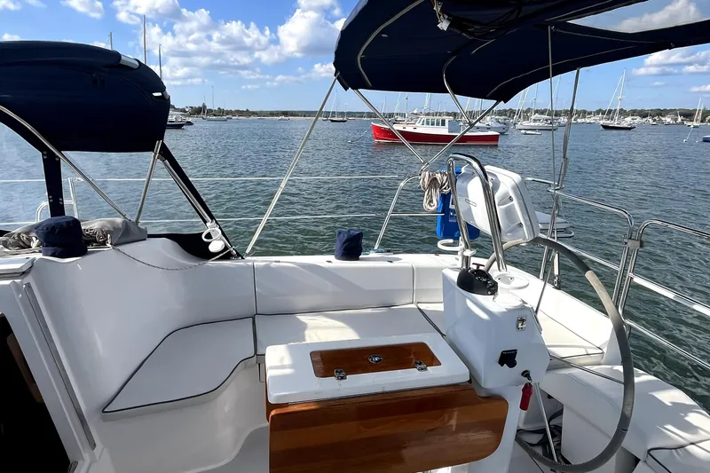 Slide: The Image of Cockpit view of a 2004 Catalina 350 sailboat on a sunny day, with boats in the background. - 31