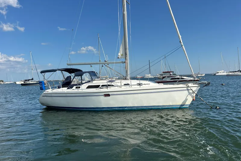 Slide: The Image of Catalina 350 sailboat from 2004 anchored in a sunny marina with clear blue skies. - 36