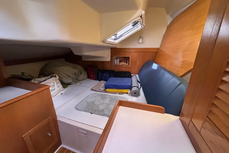 Slide: The Image of Interior cabin of a 2004 Catalina 350 sailboat with storage and seating. - 4