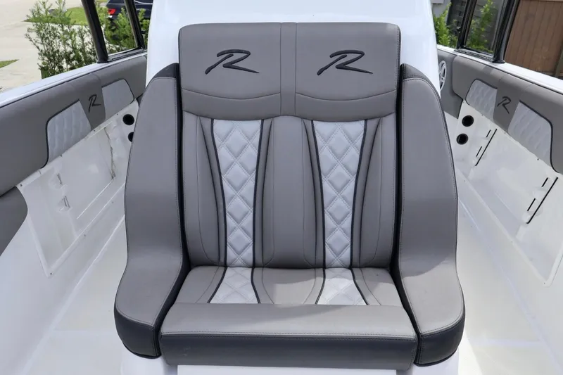 Slide: The Image of Luxurious seating in a 2008 Renegade 29CC boat, featuring elegant gray upholstery. - 3