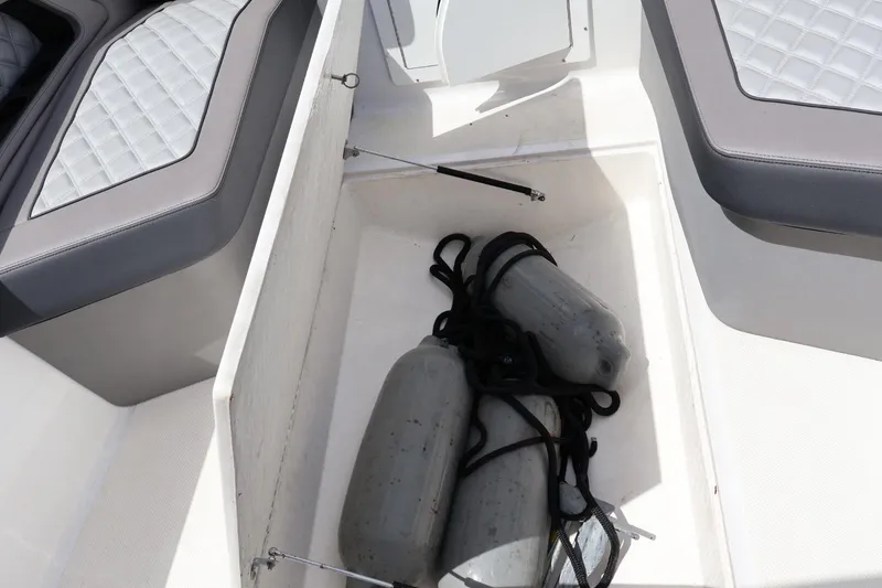 Slide: The Image of Storage compartment in a 2008 Renegade 29CC boat with fenders and ropes. - 6