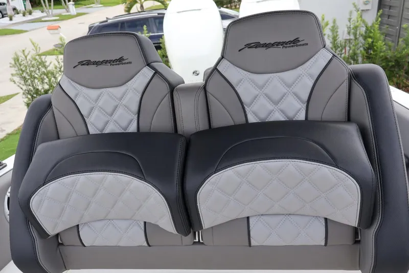 Slide: The Image of Luxurious seating on 2008 Renegade 29CC boat, featuring quilted gray and black upholstery. - 7