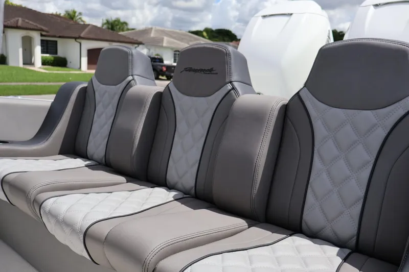 Slide: The Image of Luxurious seating on a 2008 Renegade 29CC boat, featuring quilted gray upholstery. - 9