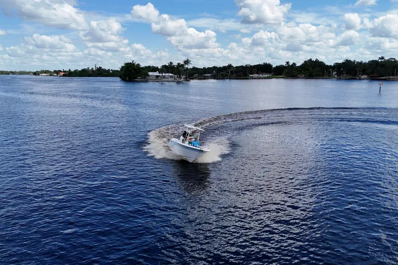 Slide: The Image of 2009 Sea Fox 230 Center Console boat making a sharp turn on a sunny day. - 7