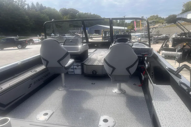 Slide: The Image of 2025 Starcraft Delta 188 DC Pro boat interior with dual seats and control console. - 15