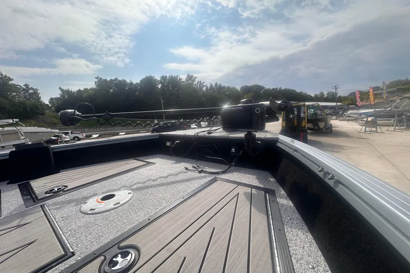 Slide: The Image of 2025 Starcraft Delta 188 DC Pro boat deck with advanced navigation equipment under a cloudy sky. - 16