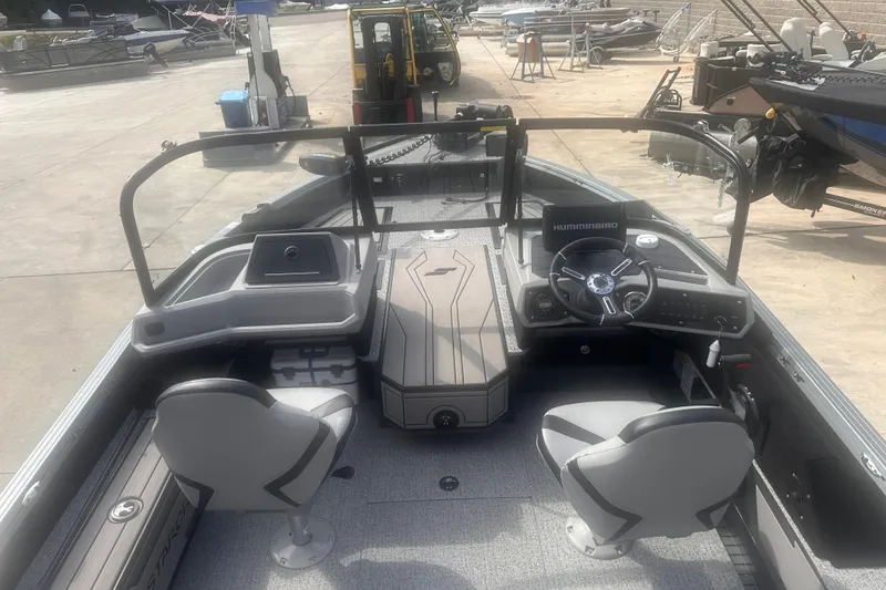 Slide: The Image of 2025 Starcraft Delta 188 DC Pro boat interior with steering console and seating. - 18