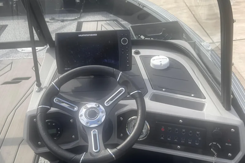Slide: The Image of 2025 Starcraft Delta 188 DC Pro boat dashboard with steering wheel and Humminbird Helix 9 display. - 19