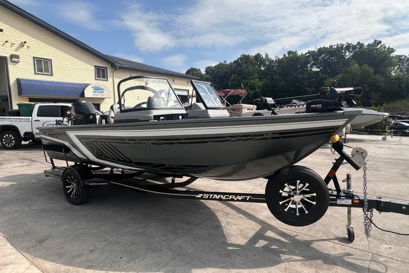 Slide: The Image of 2025 Starcraft Delta 188 DC Pro boat on trailer at marina. - 2