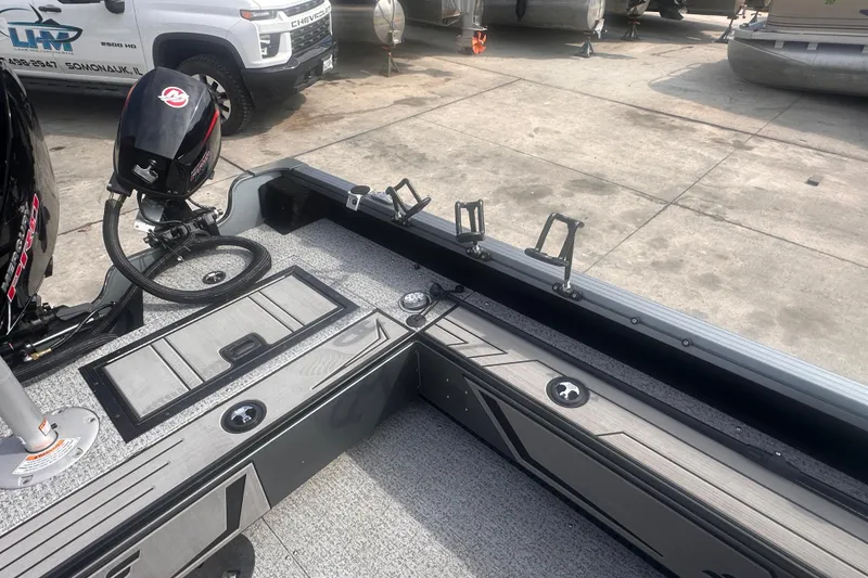 Slide: The Image of 2025 Starcraft Delta 188 DC Pro boat interior with motor and rod holders. - 24