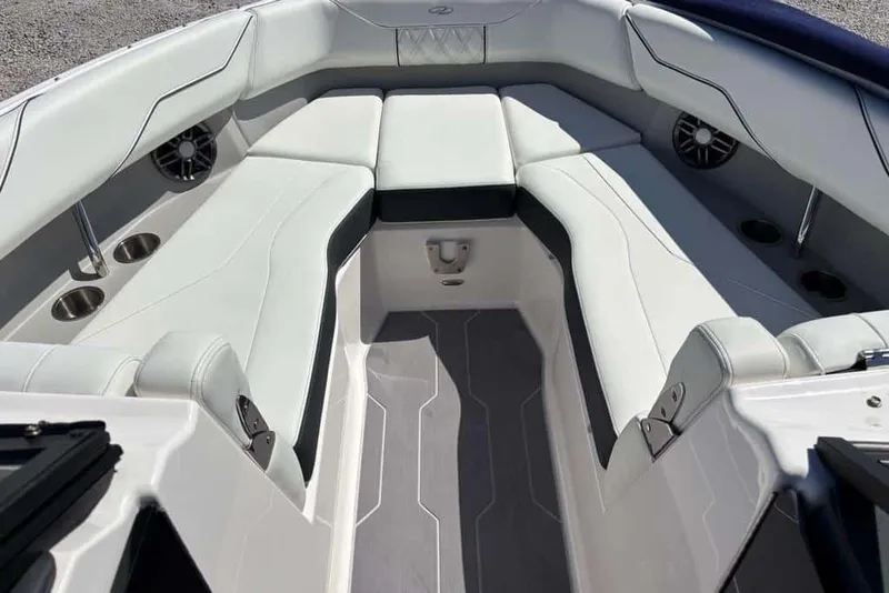 Slide: The Image of Luxurious interior of 2023 Regal LX4 boat with white seating and cup holders. - 4