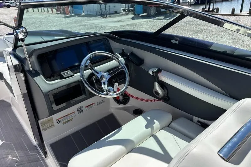 Slide: The Image of 2023 Regal LX4 boat cockpit with modern steering wheel and dashboard controls. - 6