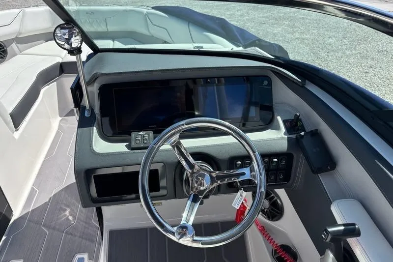 Slide: The Image of 2023 Regal LX4 boat dashboard with steering wheel and control panel. - 7