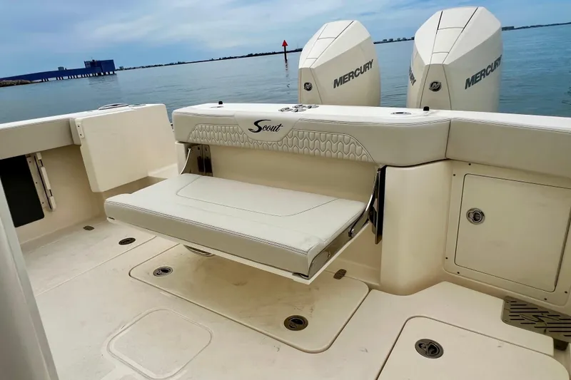 Slide: The Image of 2026 Scout 288 LXF boat with Mercury engines, featuring a foldable seat and storage compartments. - 19
