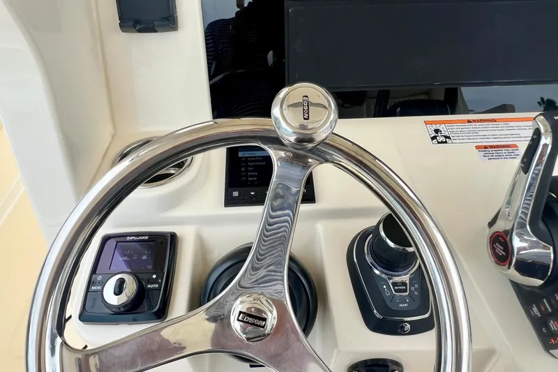 Slide: The Image of Steering wheel and controls of 2026 Scout 288 LXF boat cockpit. - 24