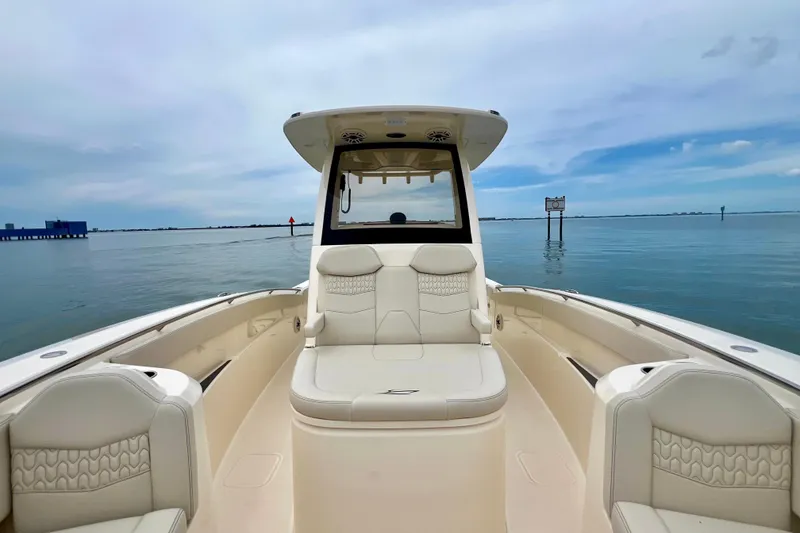 Slide: The Image of 2026 Scout 288 LXF boat interior with luxurious seating on calm water. - 26