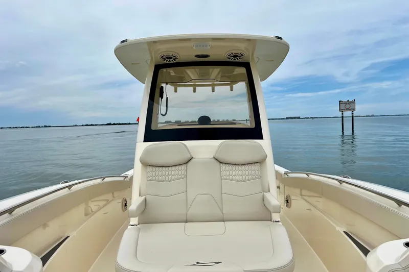 Slide: The Image of 2026 Scout 288 LXF boat on calm water, featuring luxurious seating and sleek design. - 27