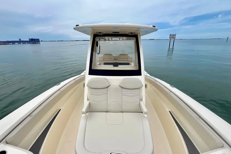 Slide: The Image of 2026 Scout 288 LXF boat on calm water, showcasing sleek design and spacious seating. - 28