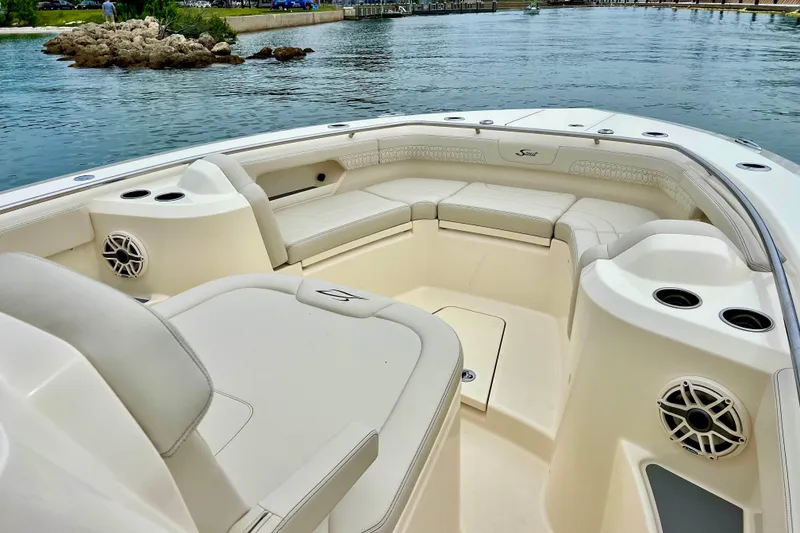Slide: The Image of Luxurious seating area on 2026 Scout 288 LXF boat, featuring cup holders and speakers. - 29