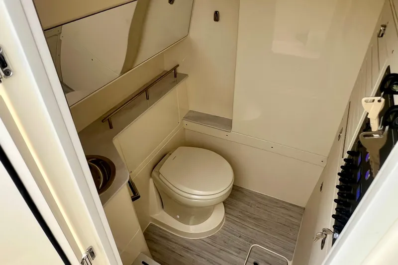 Slide: The Image of 2026 Scout 288 LXF boat bathroom with toilet and sink, featuring modern design. - 36