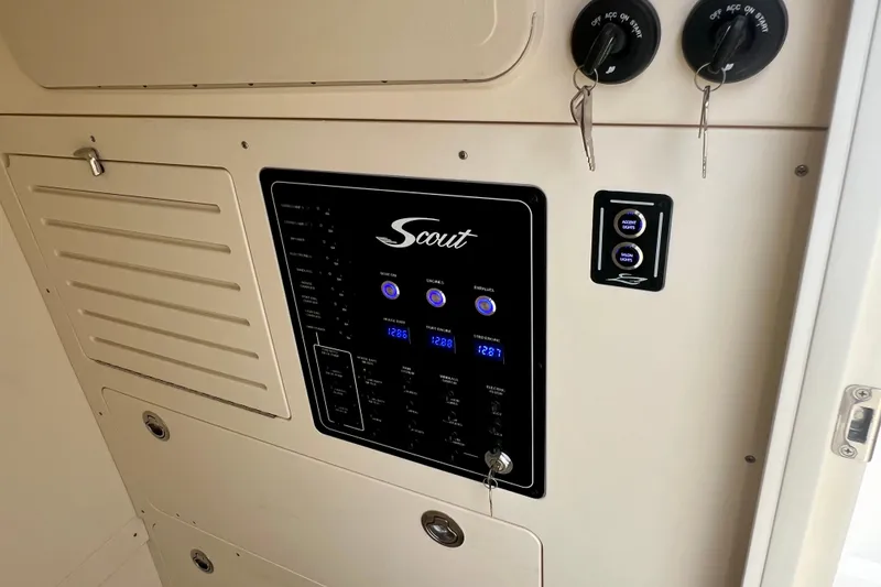 Slide: The Image of Control panel of 2026 Scout 288 LXF boat with switches and keys. - 38