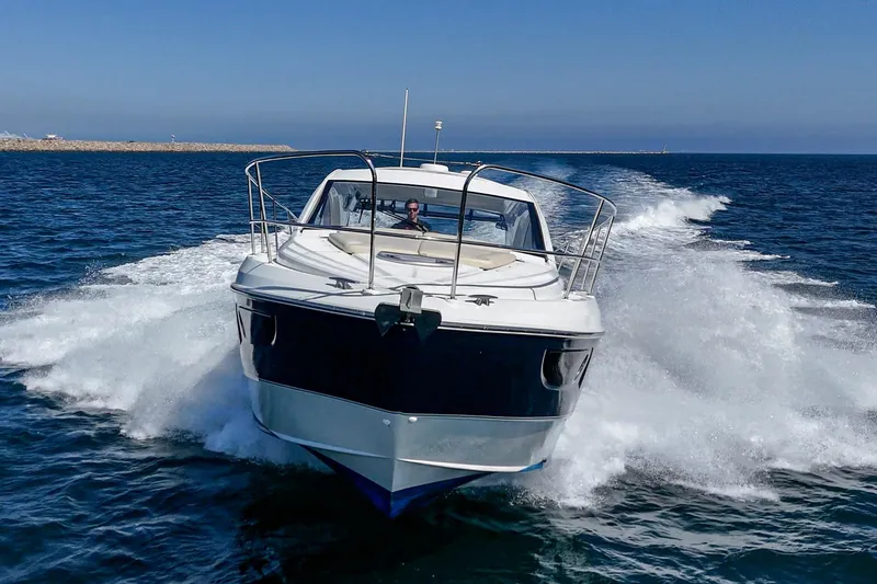 Slide: The Image of 2014 Beneteau Gran Turismo 38 yacht cruising on open water, creating waves. - 17