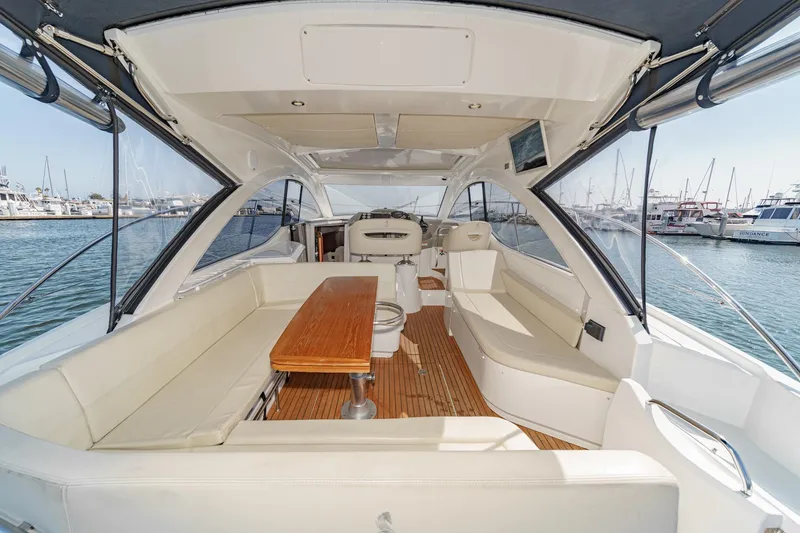 Slide: The Image of 2014 Beneteau Gran Turismo 38 yacht interior with spacious seating and wooden table. - 21