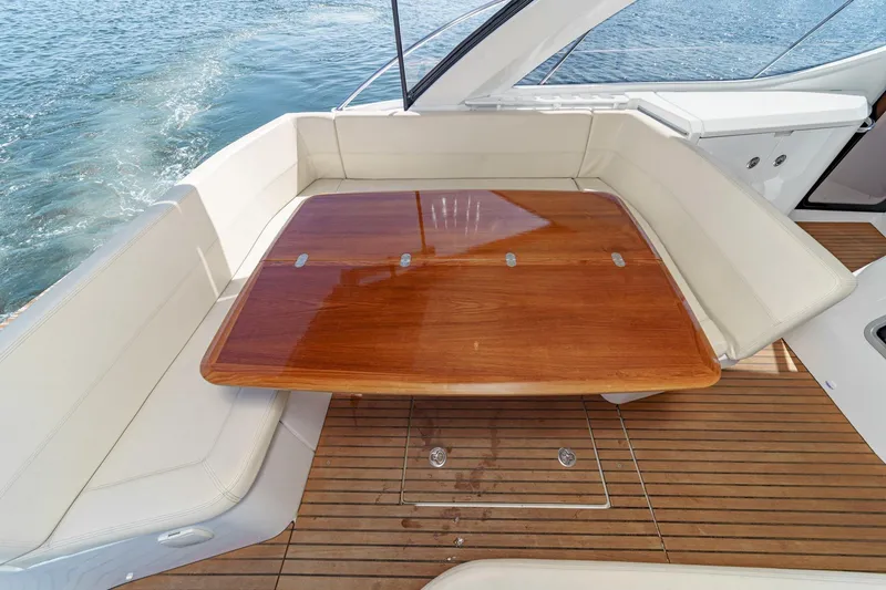 Slide: The Image of Luxury seating area on 2014 Beneteau Gran Turismo 38 yacht with wooden table. - 24