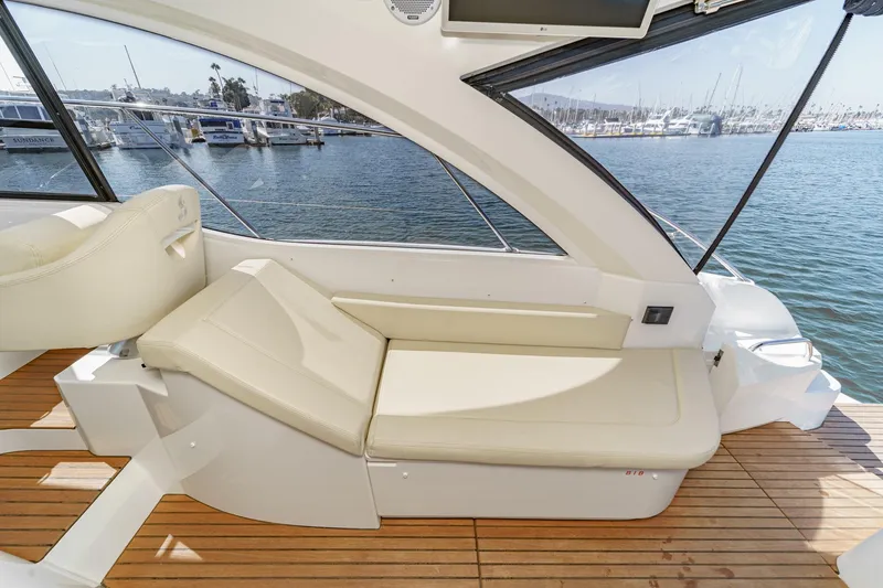 Slide: The Image of Interior of 2014 Beneteau Gran Turismo 38 yacht with beige seating and wooden deck. - 27
