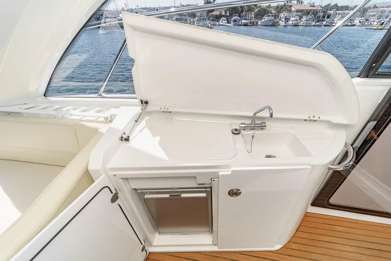 Slide: The Image of 2014 Beneteau Gran Turismo 38 yacht kitchenette with sink and storage, overlooking marina. - 28