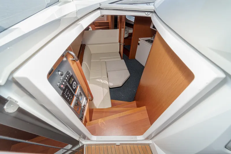 Slide: The Image of Interior view of 2014 Beneteau Gran Turismo 38 yacht, featuring seating and control panel. - 35