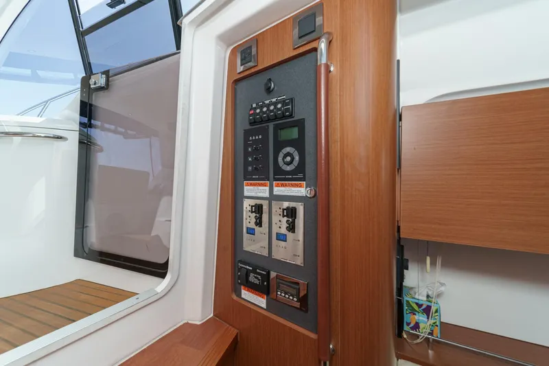 Slide: The Image of Control panel inside 2014 Beneteau Gran Turismo 38 yacht, featuring wood accents and modern design. - 36