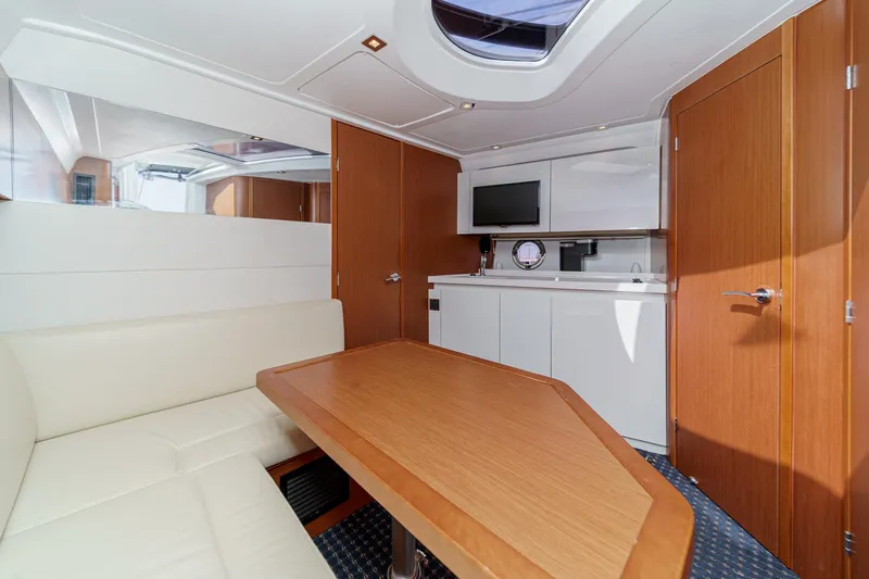 Slide: The Image of Interior of 2014 Beneteau Gran Turismo 38 yacht with modern kitchen and seating area. - 39