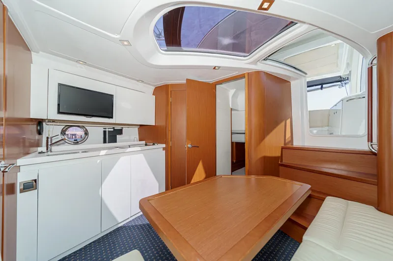 Slide: The Image of Interior of 2014 Beneteau Gran Turismo 38 yacht with modern wood finish and skylight. - 40