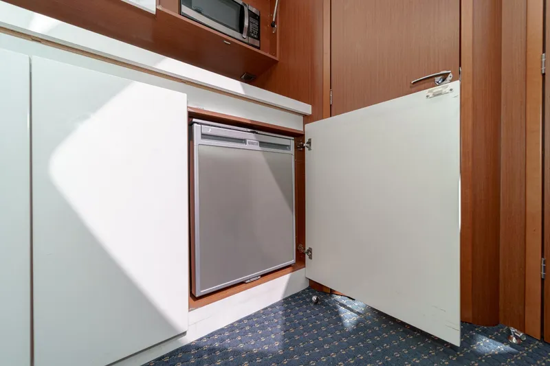 Slide: The Image of Interior of 2014 Beneteau Gran Turismo 38 yacht with open cabinet and compact fridge. - 42