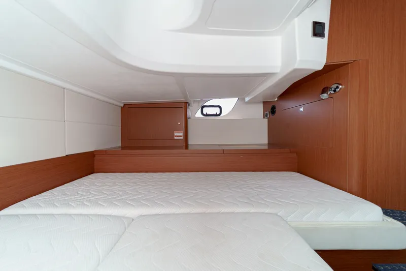 Slide: The Image of Interior cabin of 2014 Beneteau Gran Turismo 38 with wooden finish and comfortable bedding. - 45
