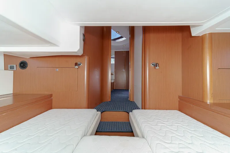 Slide: The Image of Interior of 2014 Beneteau Gran Turismo 38 yacht with twin beds and wooden finish. - 46